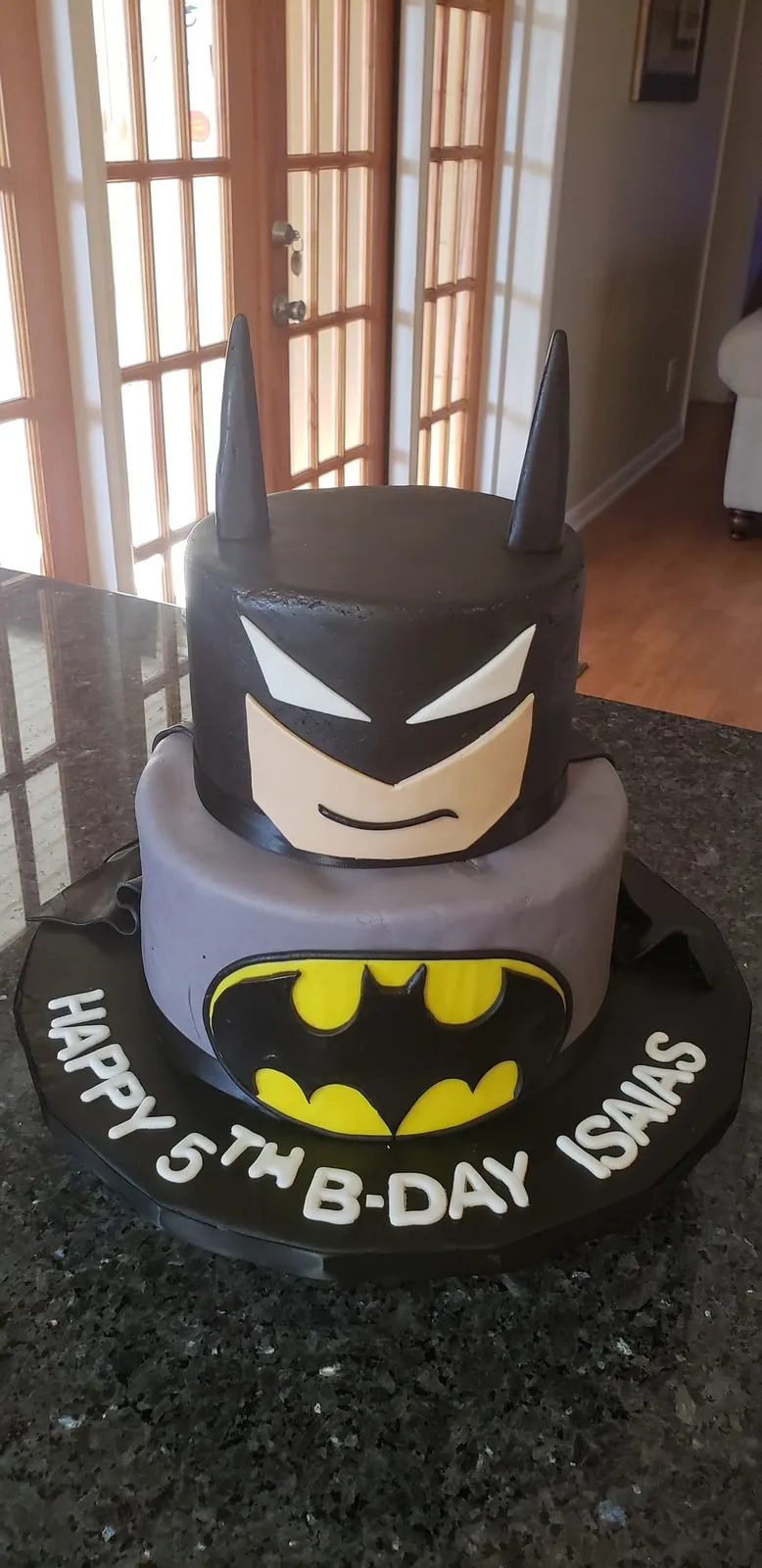 Sculpted Batman birthday cake with hand modelled cowl for a fifth birthday