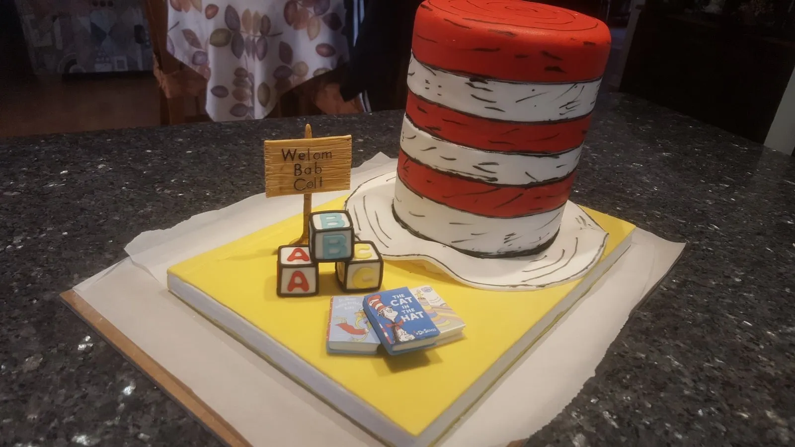 Cat in the Hat cake with a sculpted red and white striped hat and fondant blocks