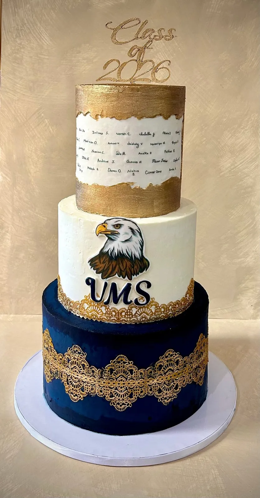 Three tier Class of 2026 graduation cake with a hand painted eagle crest