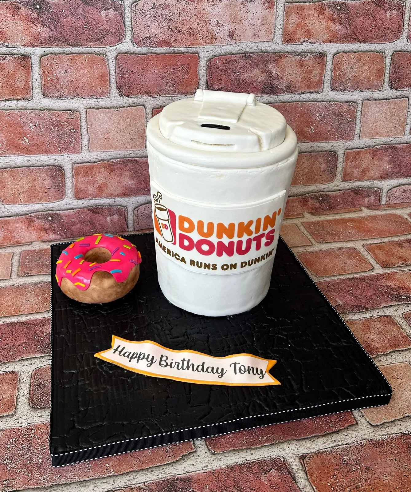 Sculpted Dunkin coffee cup cake with a matching fondant doughnut