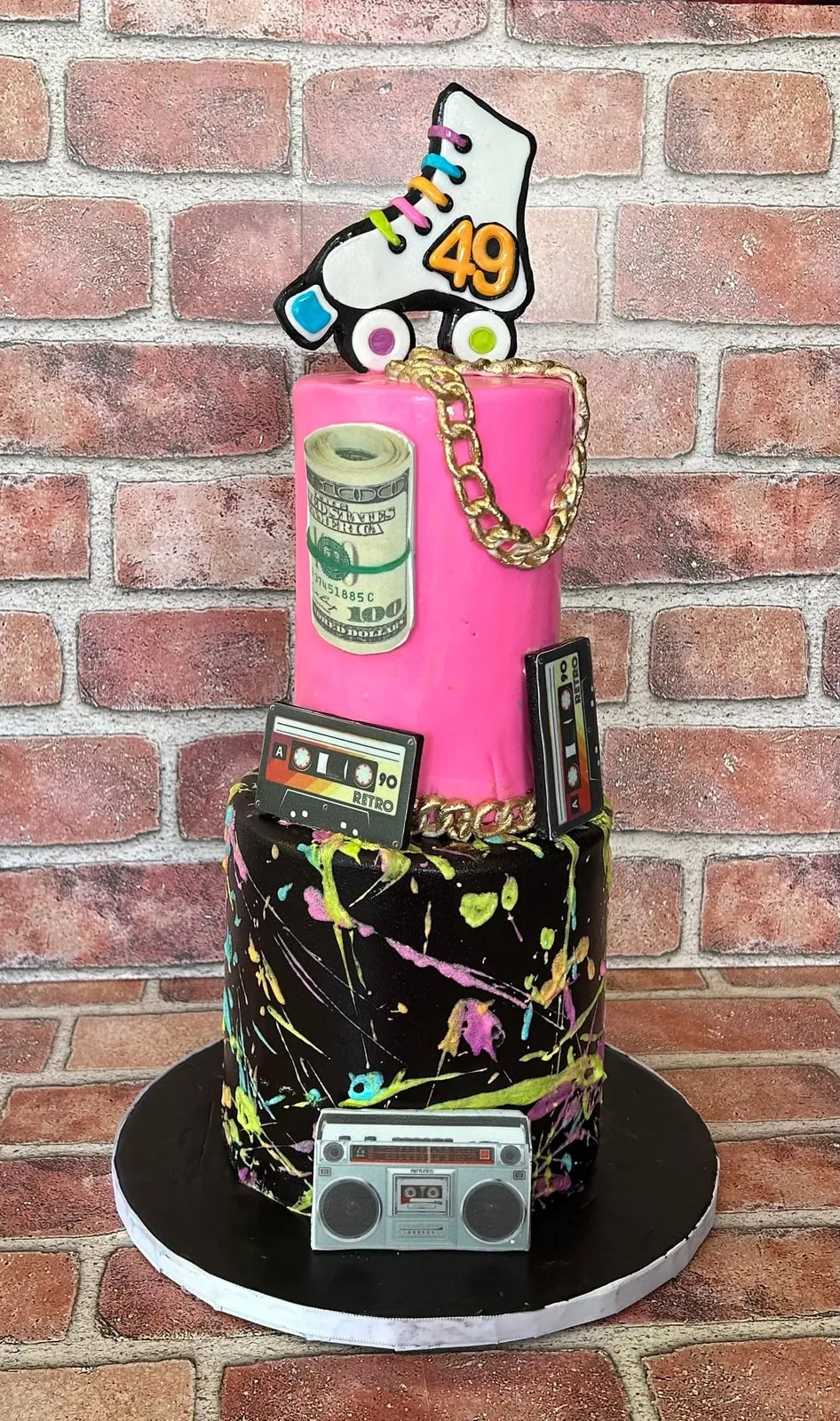 Eighties themed sculpted cake with a fondant boombox, roller skate and neon splatter