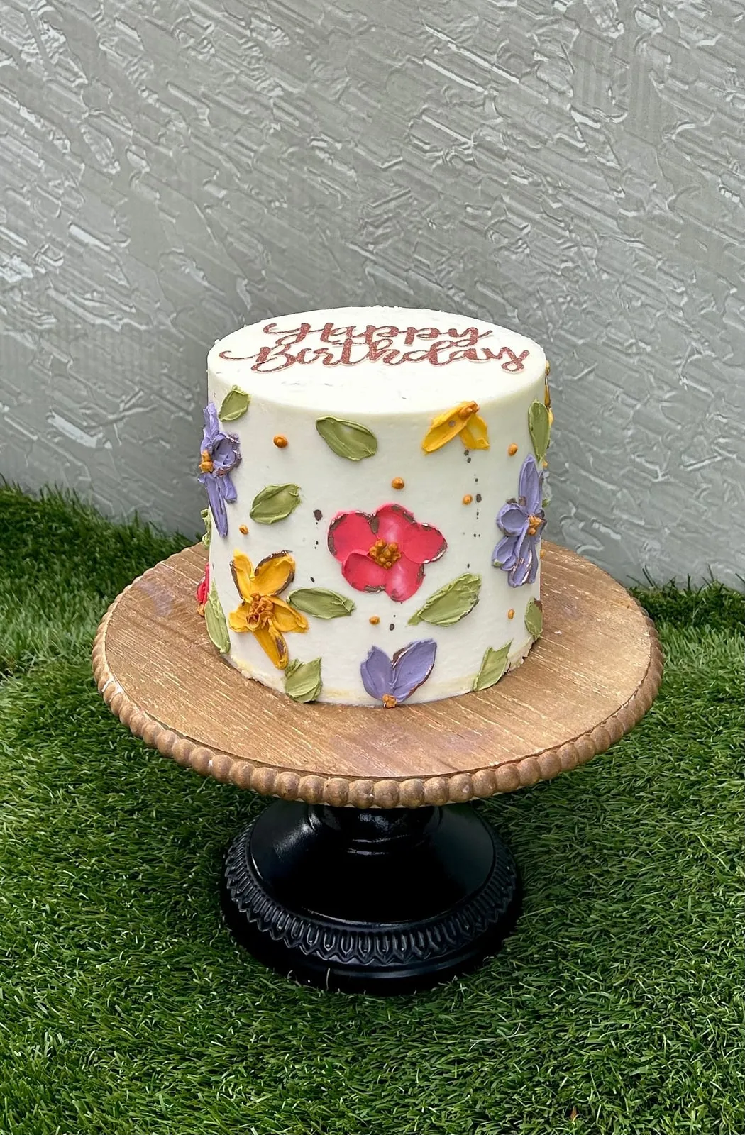 Ivory birthday cake hand painted with colourful folk art flowers