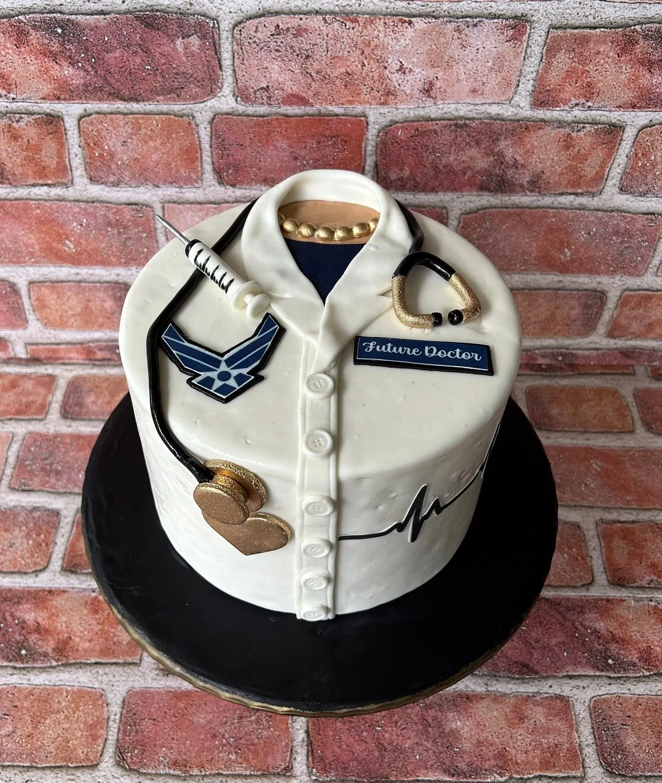 Sculpted white doctor coat cake with stethoscope and Air Force insignia