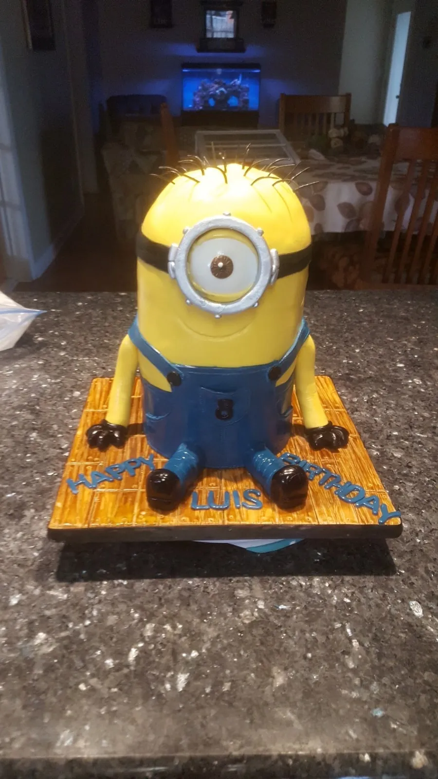 Sculpted Minion birthday cake with goggles and denim overalls