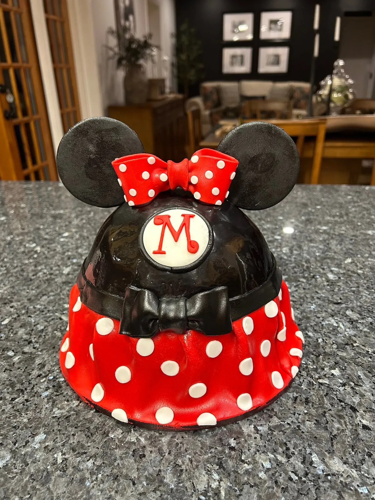 Minnie Mouse tiered cake in red polka dot fondant with sculpted ears and bow