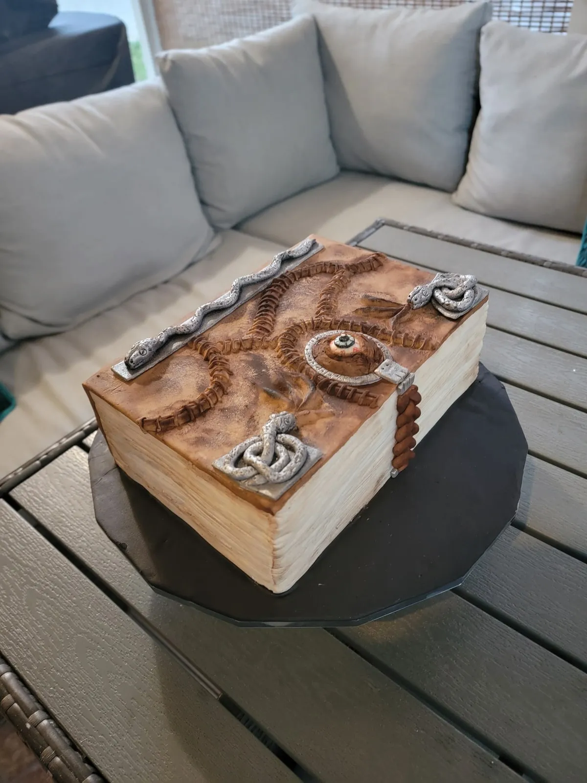 Sculpted open book cake with hand painted pages and a carved wood effect