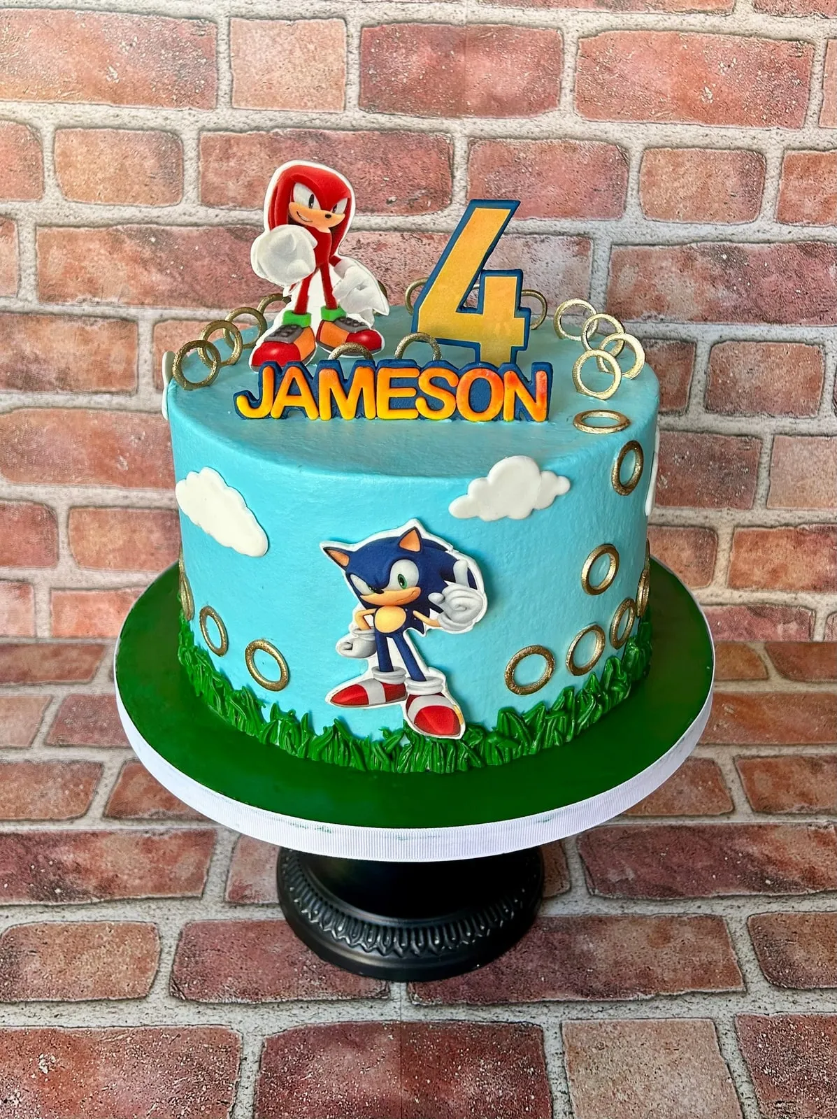 Sonic the Hedgehog birthday cake with hand cut fondant figures on a grass base