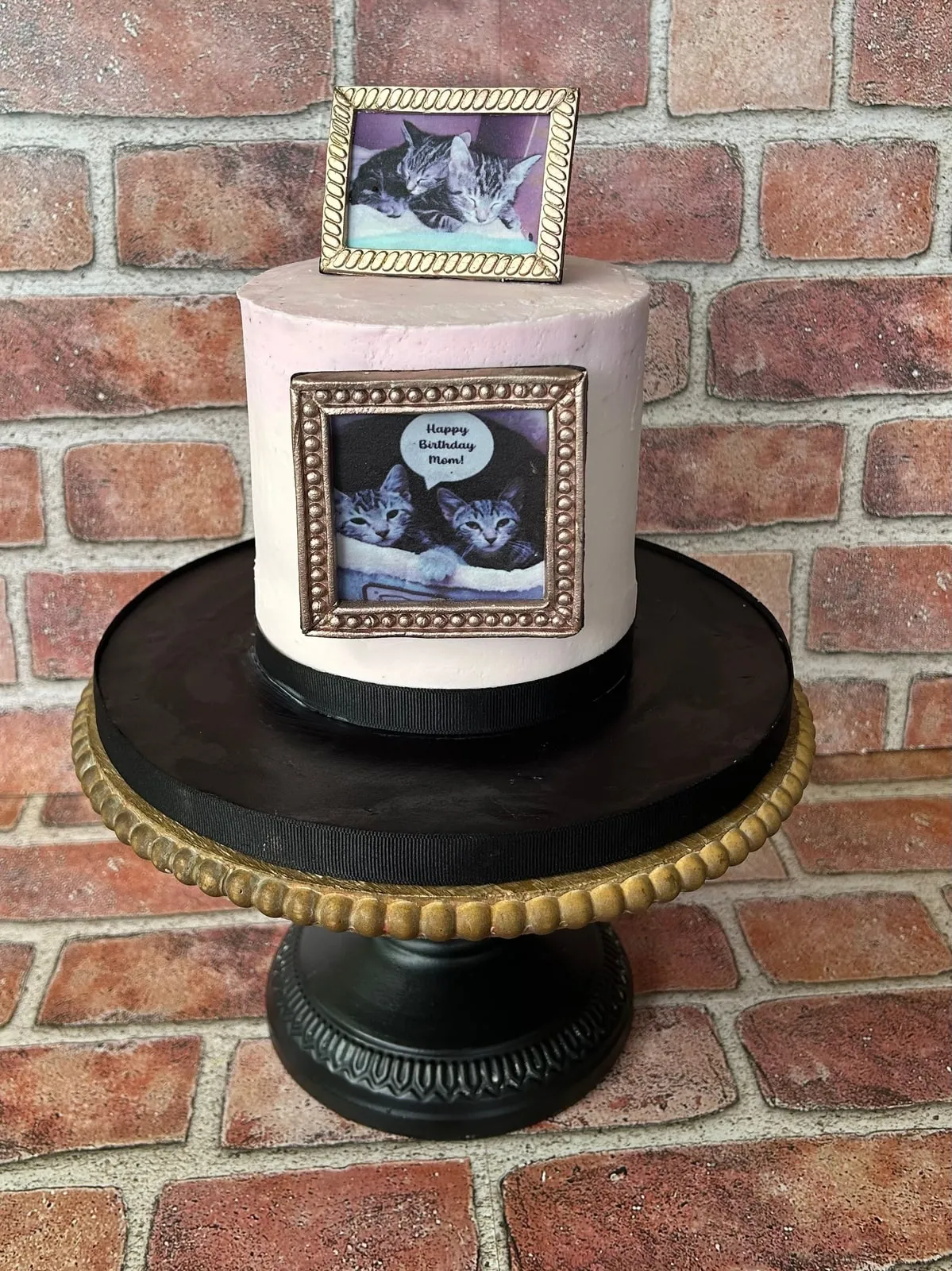 Gender reveal cake with framed sonogram plaques on ivory buttercream