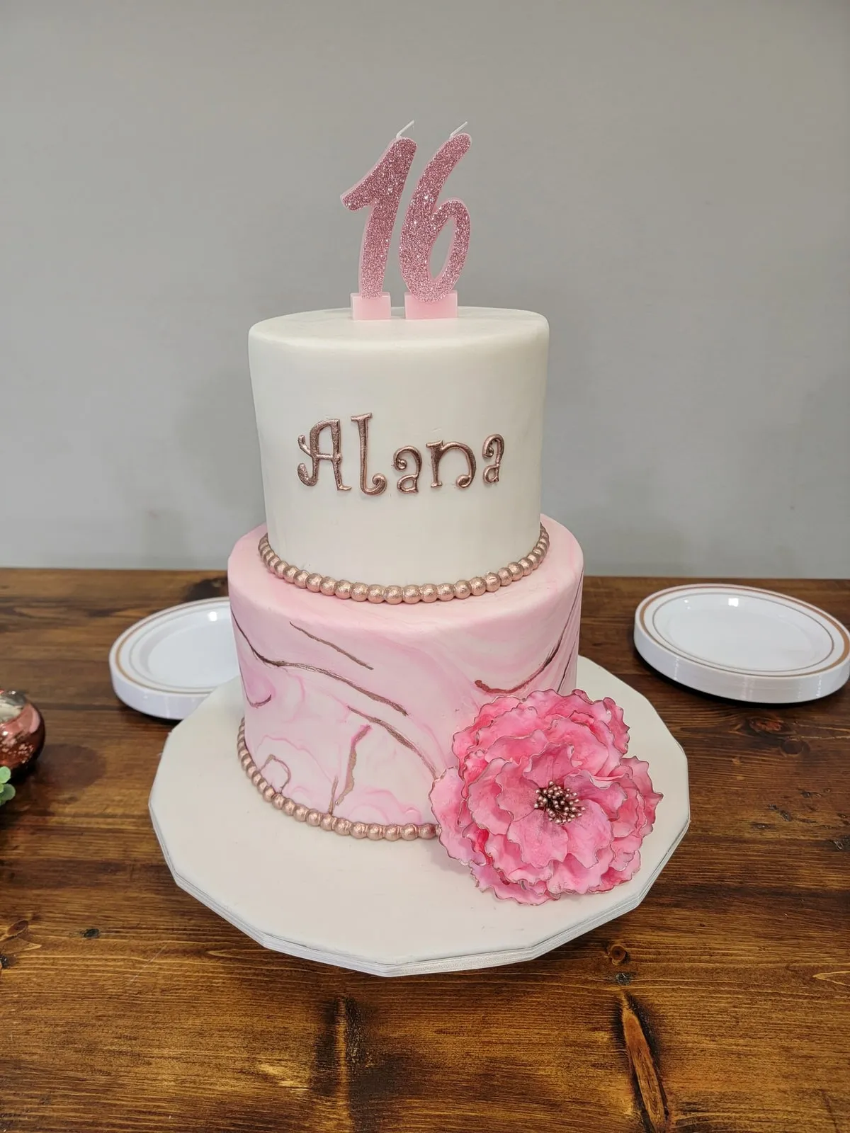 Sweet sixteen two tier cake in blush marble fondant with a sugar peony